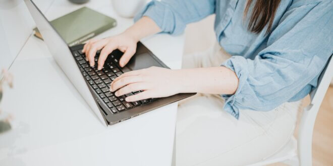 hands typing on a laptop